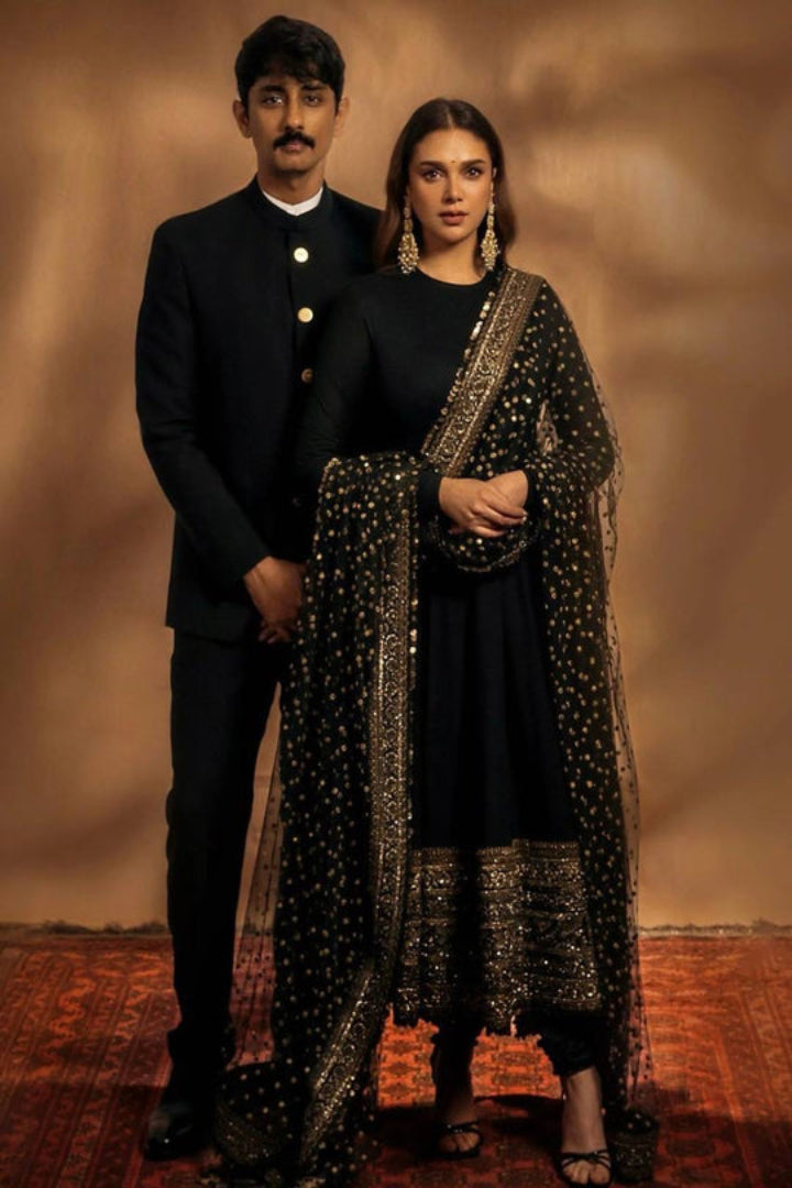 Man and woman in formal attire standing against a warm-toned background