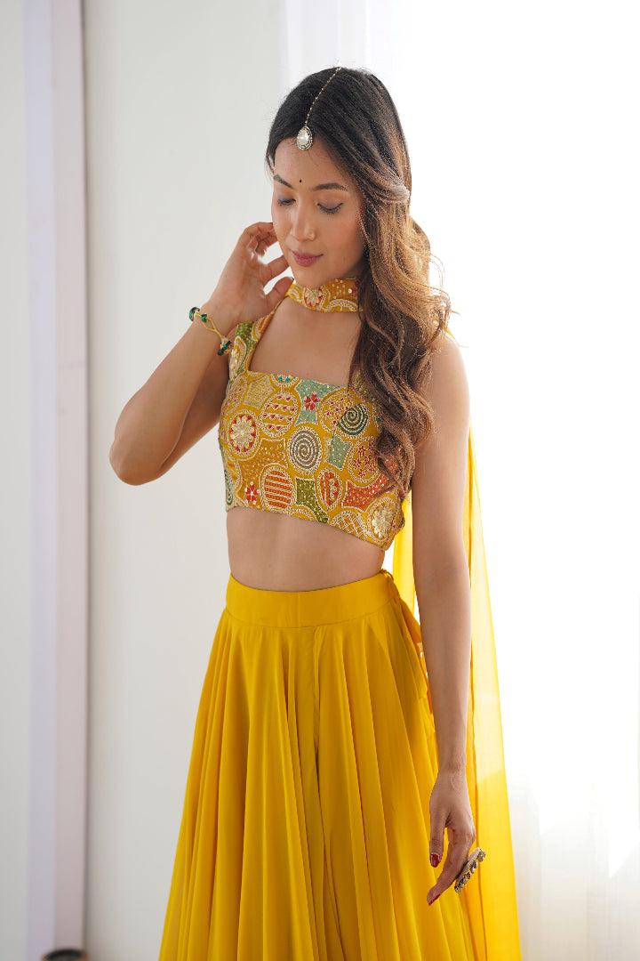Woman wearing a yellow traditional outfit with a colorful top against a white background
