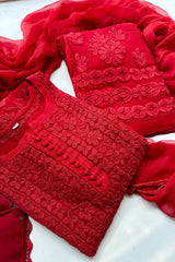 Red embroidered traditional outfit on a white background