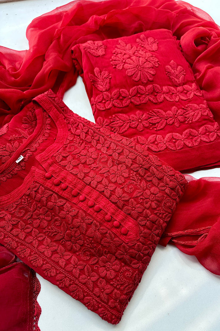 Red embroidered traditional outfit on a white background