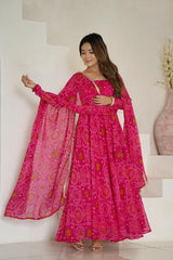 Woman wearing a pink traditional outfit with a matching dupatta indoors.