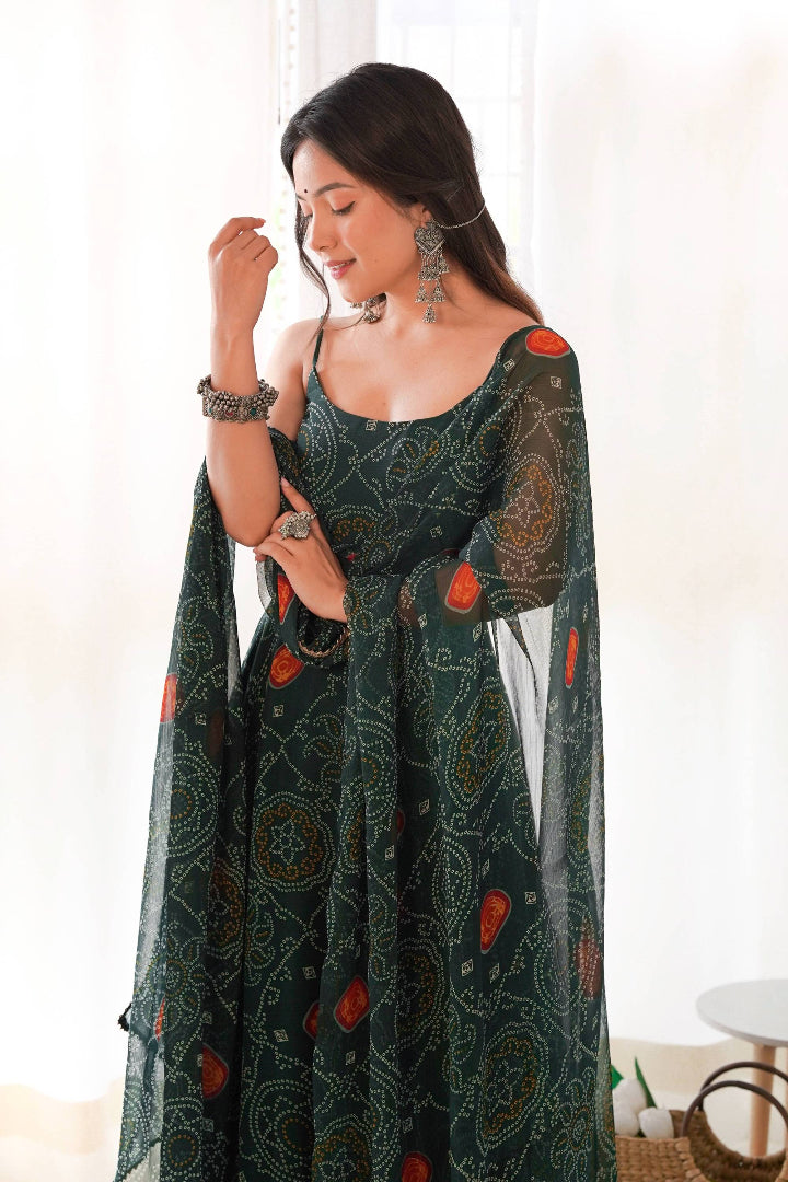 Woman wearing a dark green patterned dress with sheer sleeves indoors.