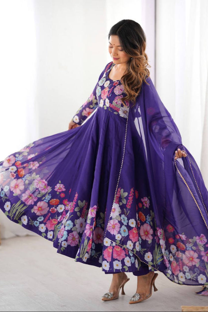 Woman wearing a purple floral dress in a bright room