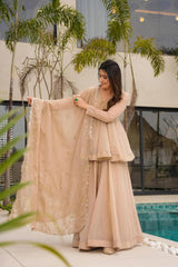 Woman in a beige traditional outfit holding a matching dupatta by a poolside.