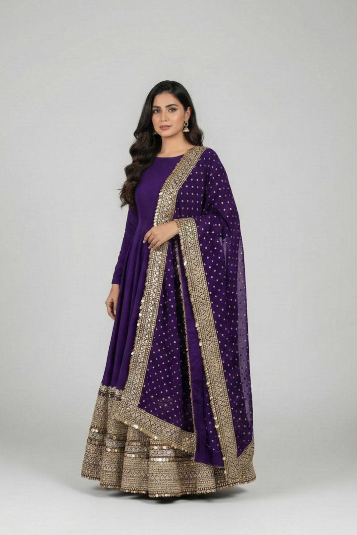 Woman wearing a purple traditional outfit with gold embroidery on a white background