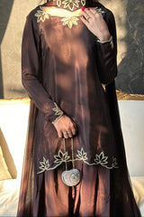 Brown dress with floral embroidery and a heart-shaped brooch on a neutral background
