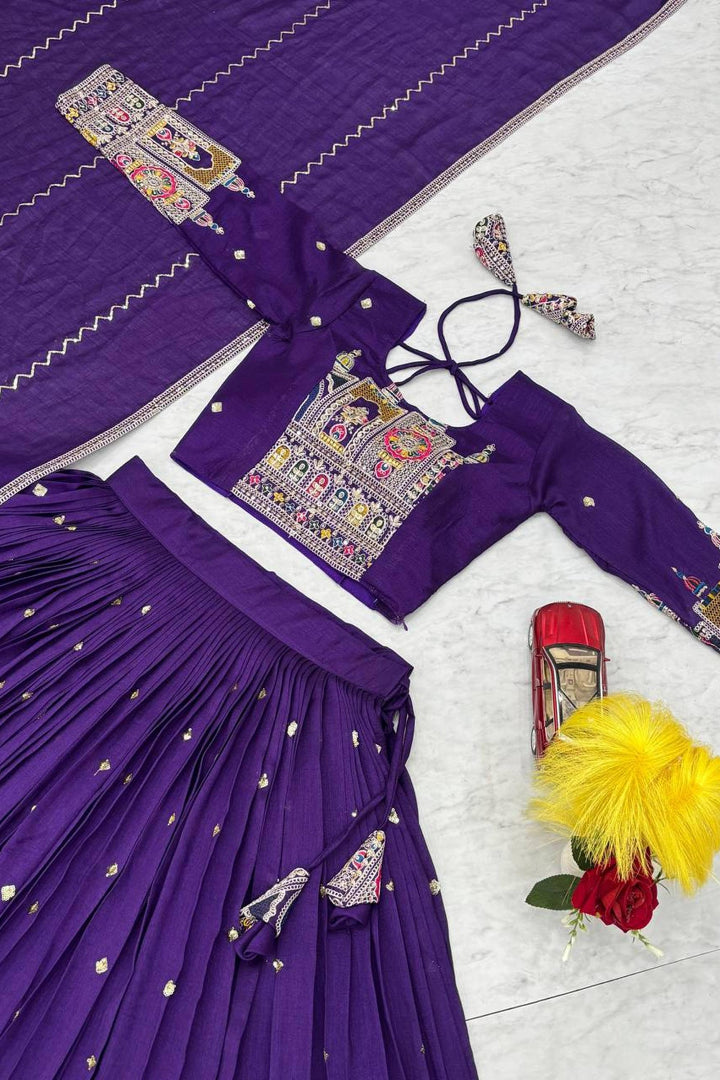 Purple traditional outfit with intricate designs on a white background