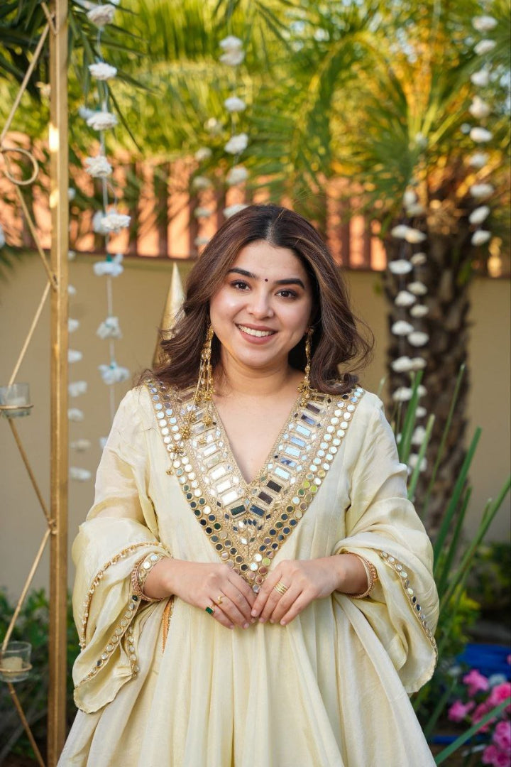 Woman in a traditional outfit with decorative elements in an outdoor setting