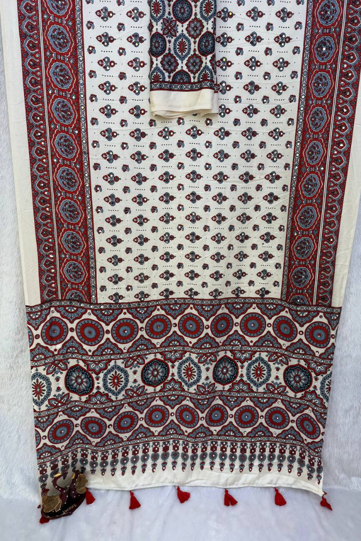 Decorative fabric with intricate patterns and tassels on a white background