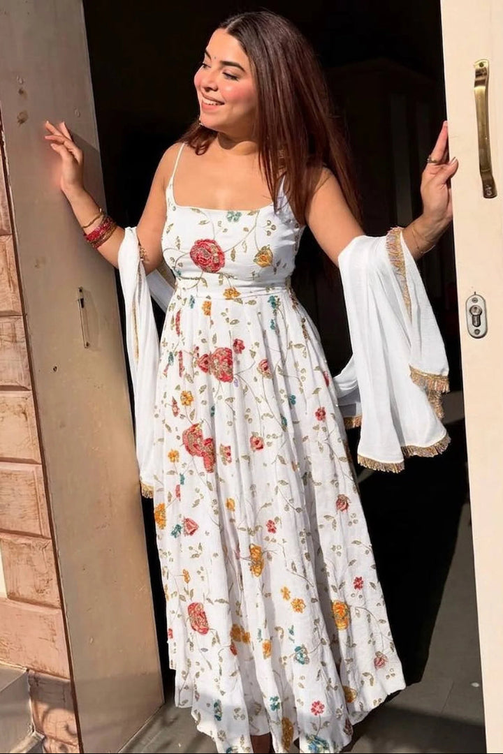 Woman in a floral dress standing in a doorway