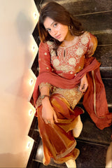 Woman in traditional outfit sitting on a staircase