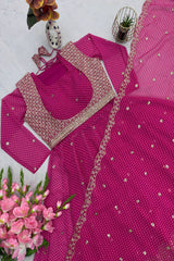 Pink embroidered traditional outfit with matching blouse and dupatta on a white background.