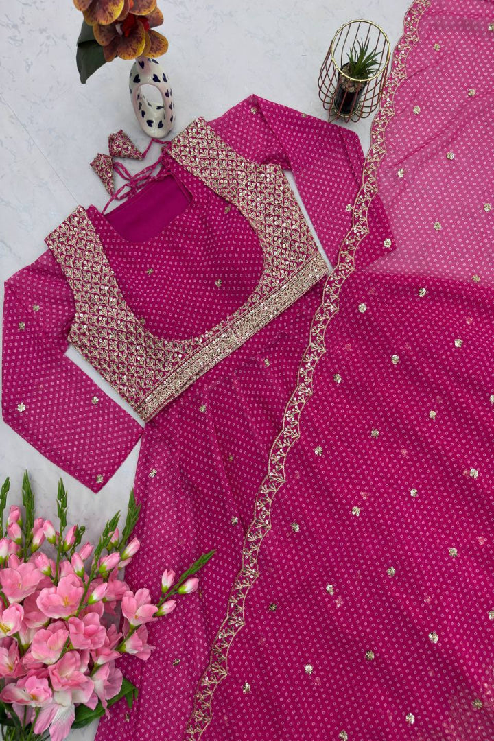 Pink embroidered traditional outfit with matching blouse and dupatta on a white background.