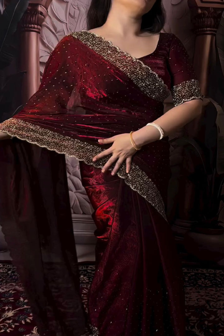 Person wearing a burgundy traditional outfit with intricate detailing.
