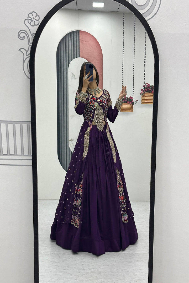 Person wearing a purple dress with floral patterns in front of a mirror.