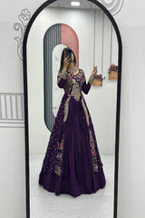 Person wearing a purple dress with floral patterns in front of a mirror.