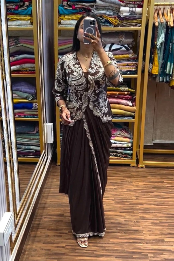 Person wearing a traditional outfit in a clothing store with shelves of clothes in the background.