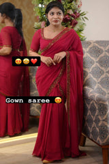 Woman in a red gown saree with decorative elements in a decorated room.