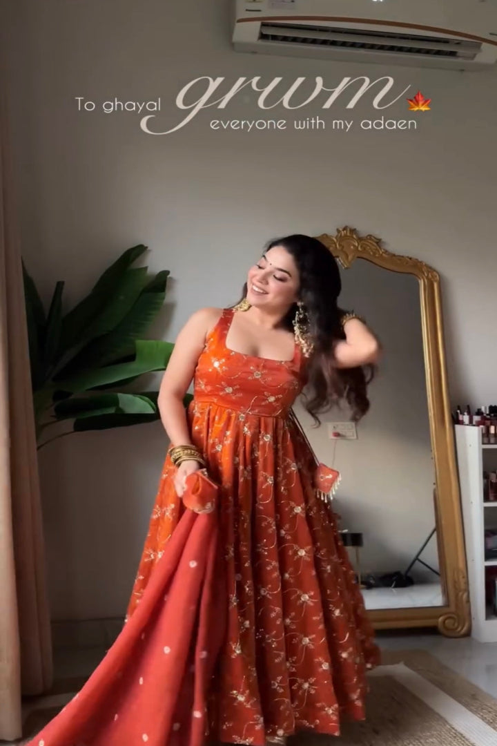 Woman in an orange dress standing in front of a mirror, with text overlay.