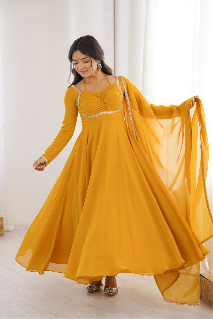 Woman wearing a yellow traditional outfit with a white background