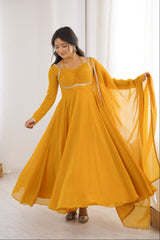 Woman wearing a yellow traditional outfit with a white background