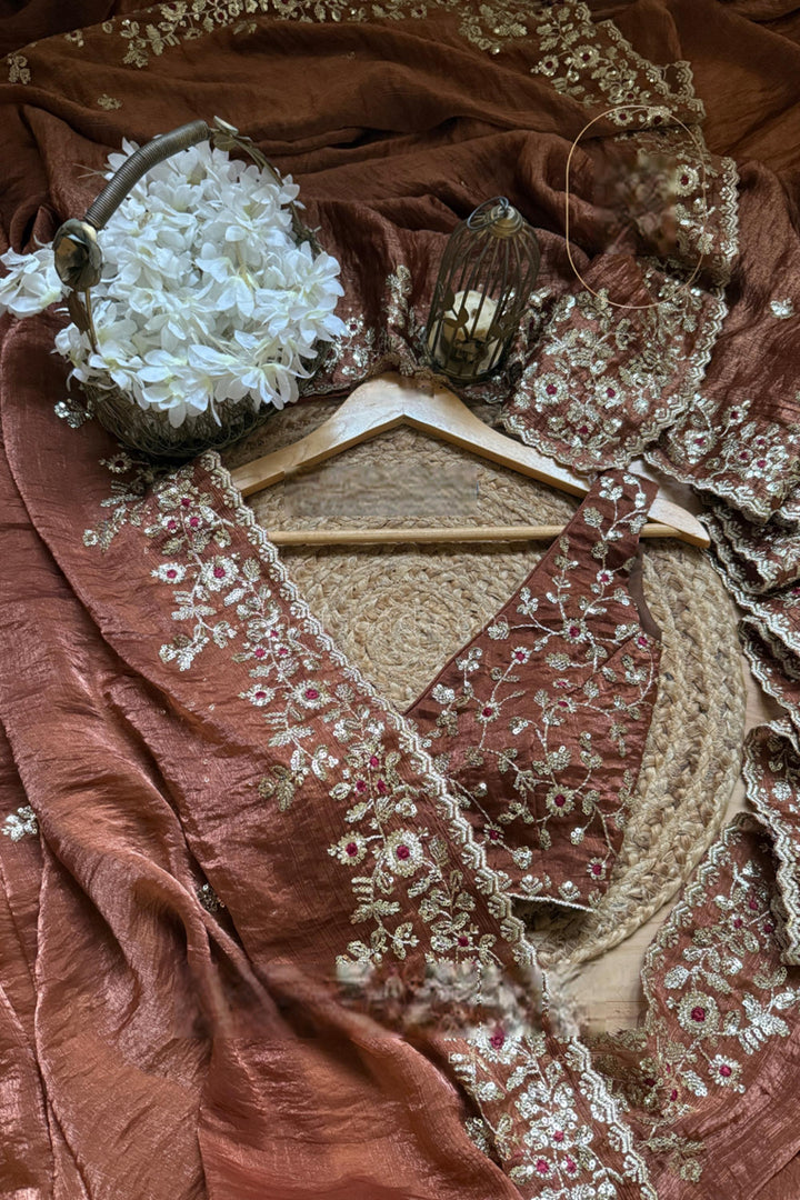 Textile with floral embroidery on a brown fabric background