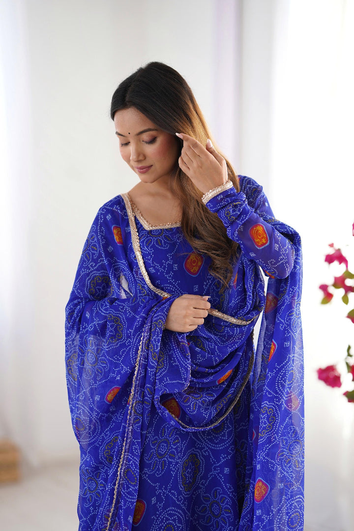 Woman wearing a blue embroidered traditional outfit with a white background