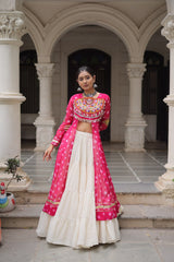 Woman in a traditional pink and white outfit standing in an architectural setting.