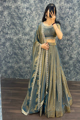 Person wearing a traditional outfit with a textured gray background