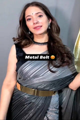 Woman wearing a metallic belt with text overlay on a plain background