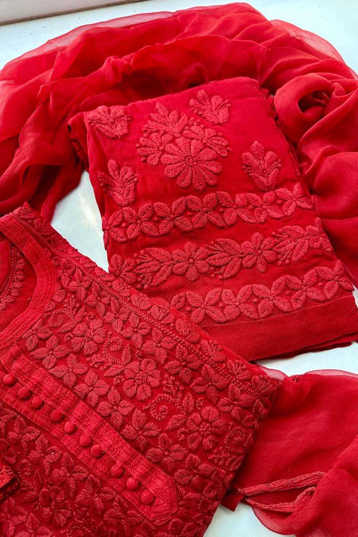 Red embroidered garment on a white background