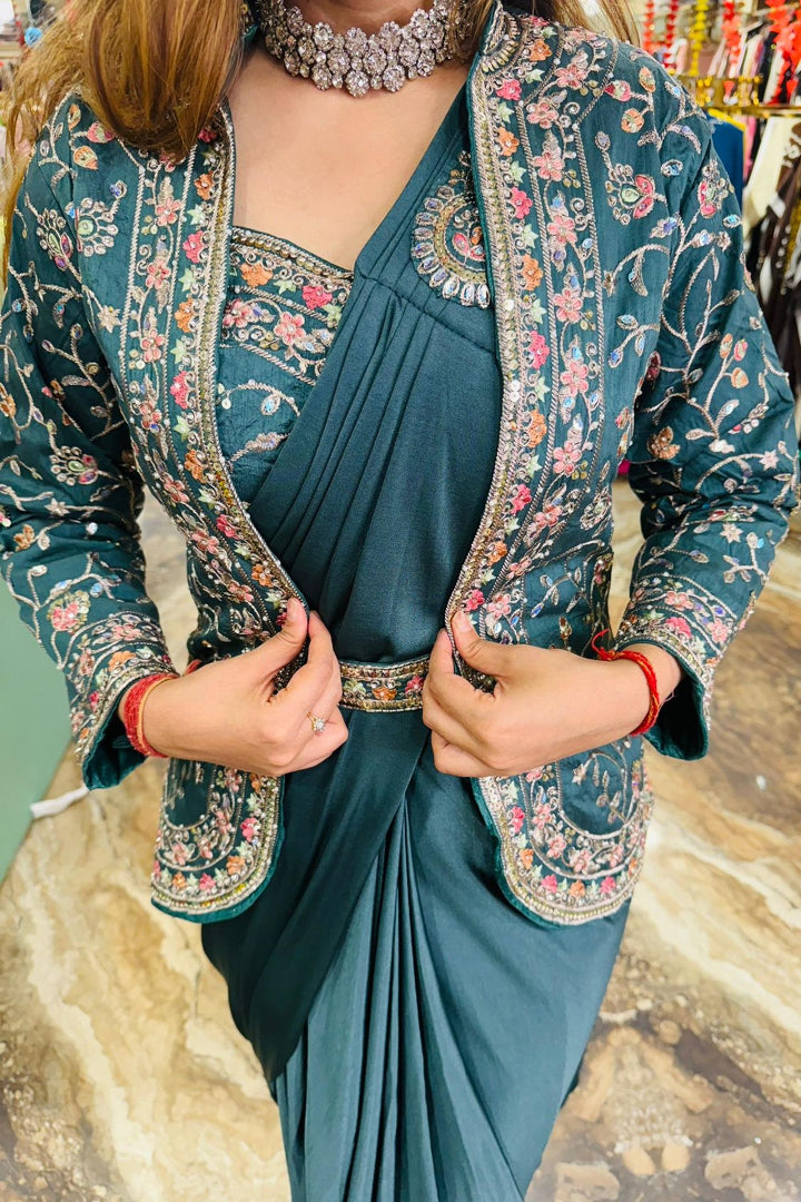 Woman wearing a teal saree with a floral blouse in a store setting