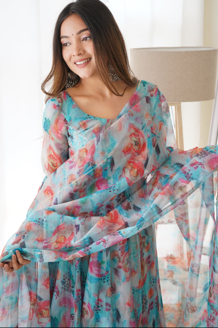 Woman wearing a floral saree in a bright indoor setting
