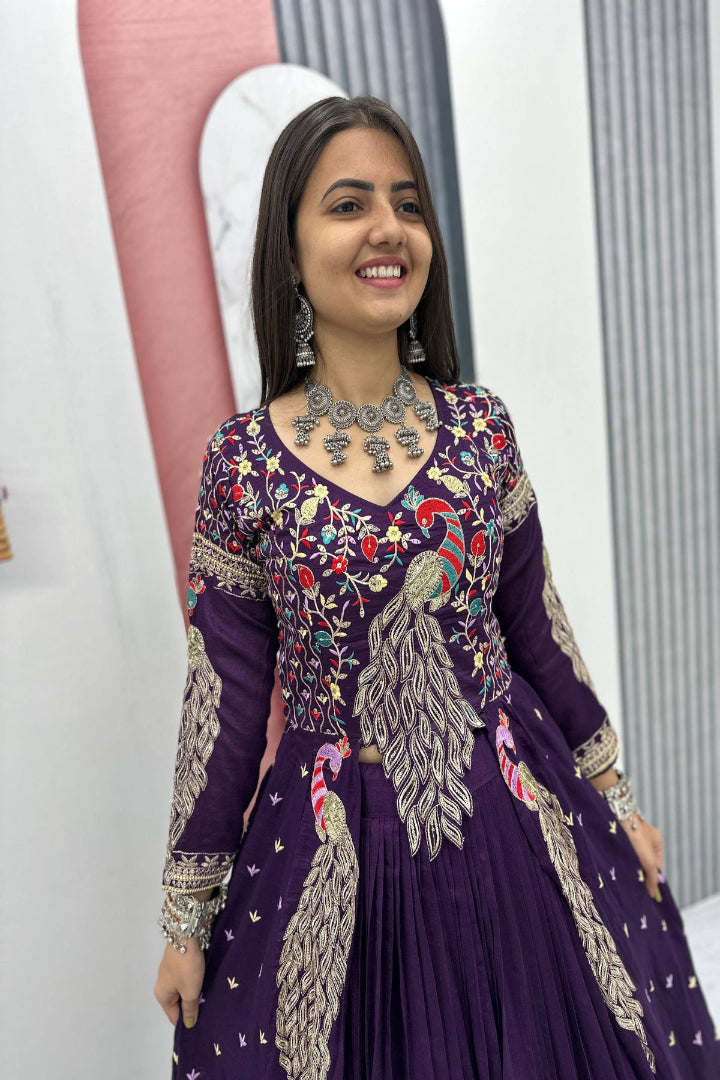Woman wearing a purple embroidered traditional outfit with a white background