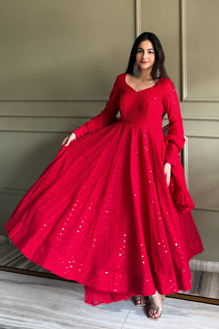 Woman wearing a red dress with long sleeves in an indoor setting