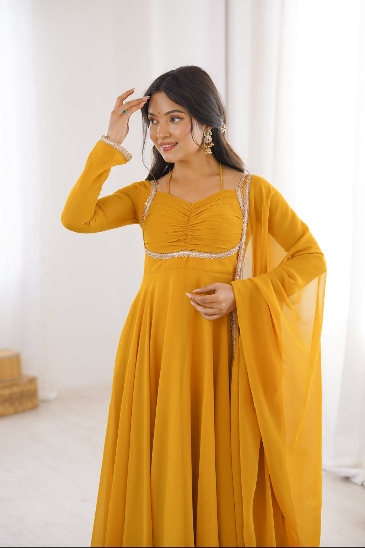 Woman wearing a mustard yellow traditional outfit with a white background