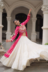 Woman in traditional pink and white outfit dancing in an architectural setting