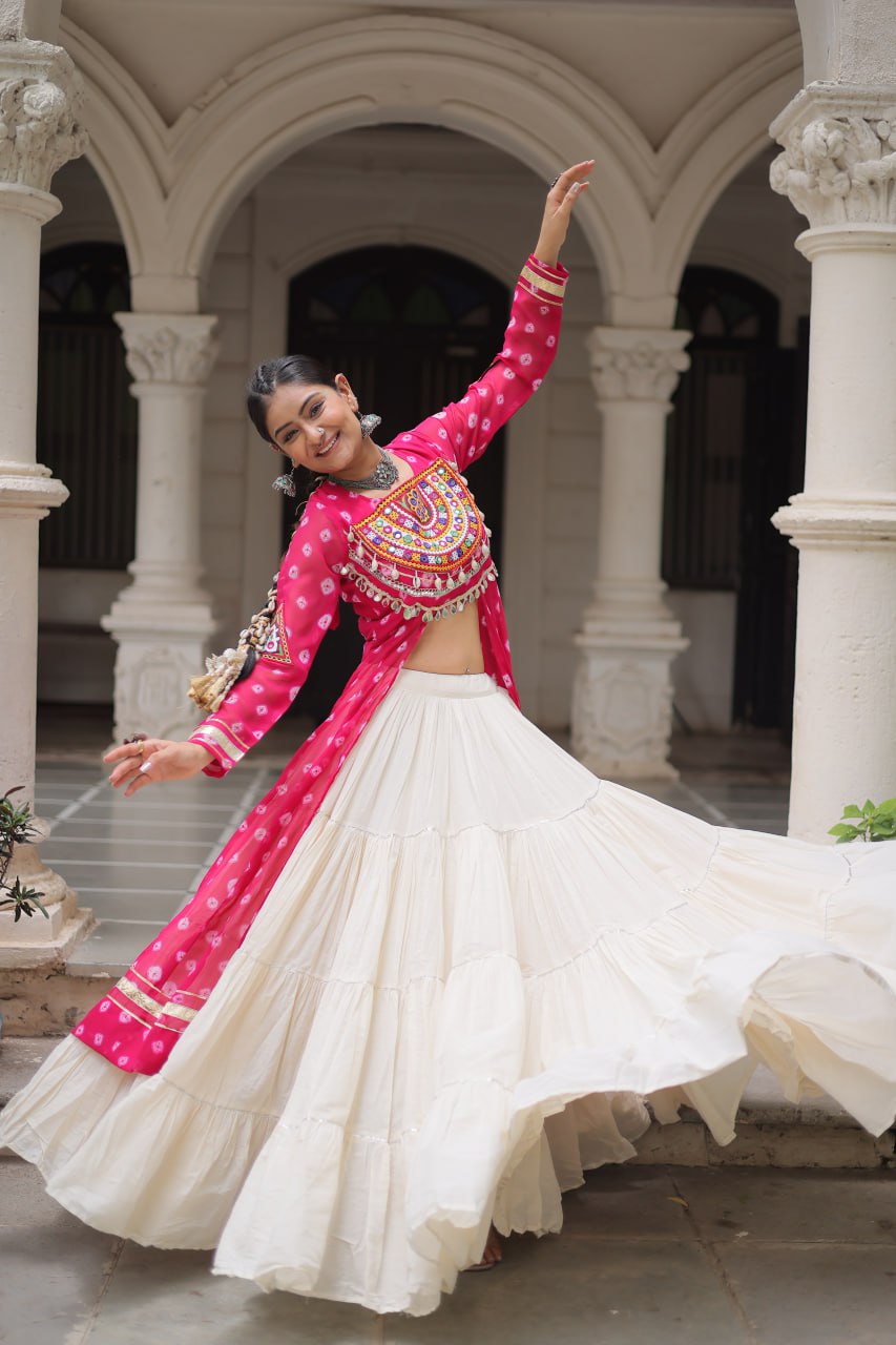 Woman in traditional pink and white outfit dancing in an architectural setting