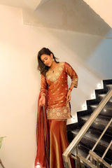 Woman in a traditional outfit standing on a staircase