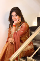 Woman in a traditional outfit standing on a staircase