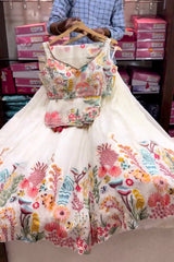 Floral dress on a hanger with a blurred background of boxes.