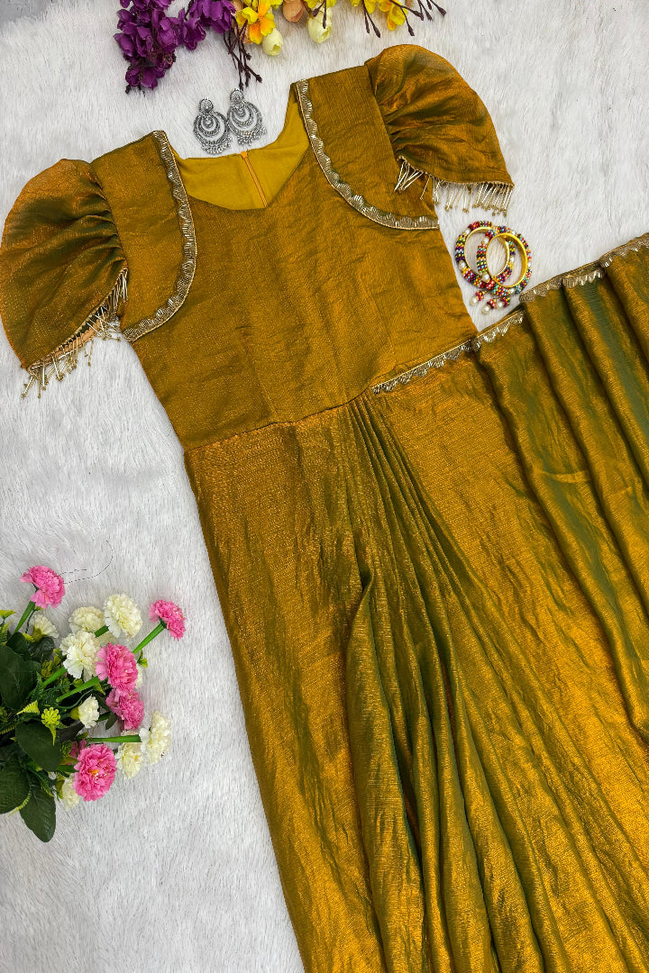 Mustard yellow traditional dress with floral decorations on a light gray background