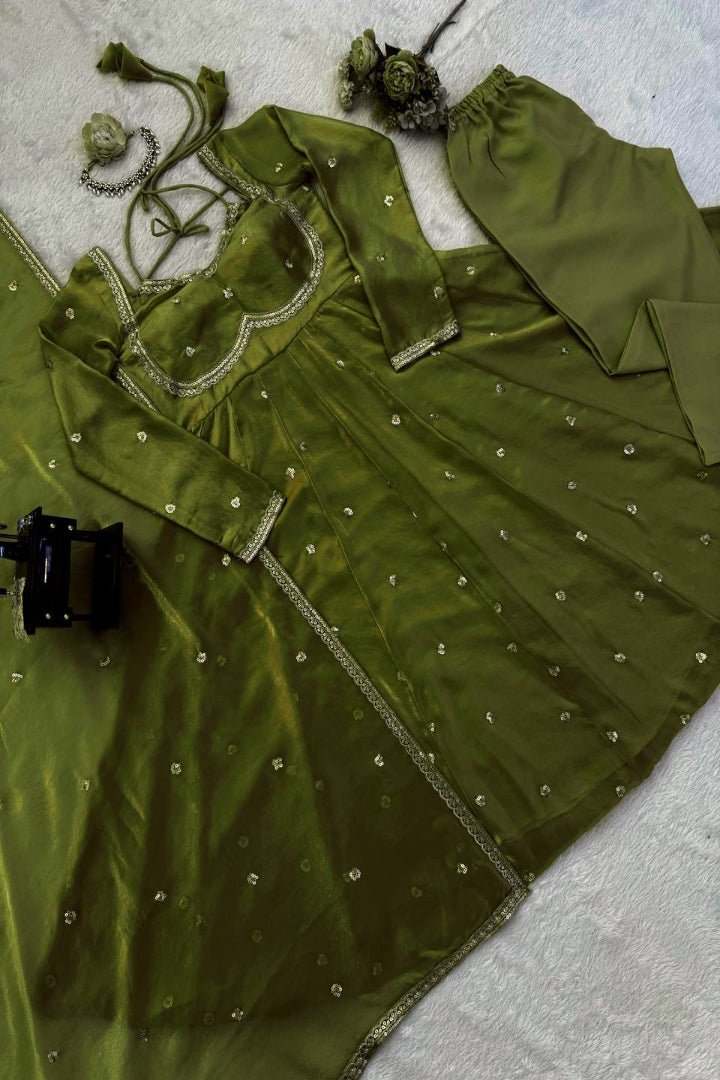 Green embroidered garment on a textured surface