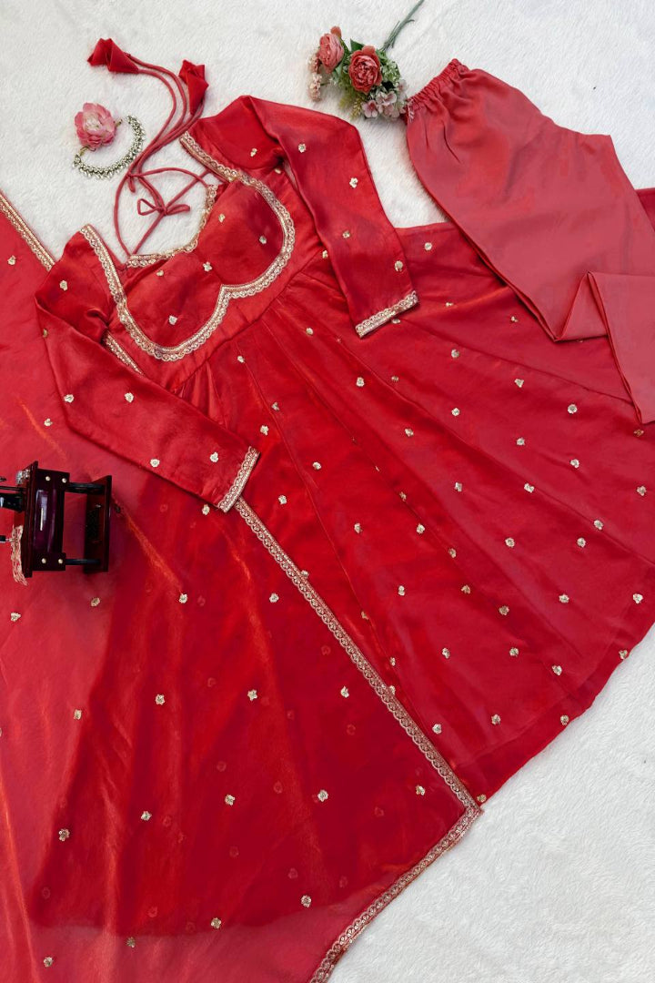 Red traditional outfit with gold embroidery on a white background